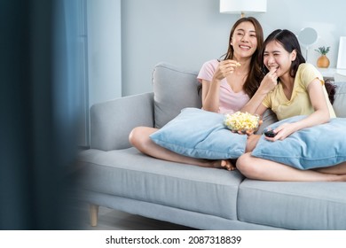 Asian Beautiful Lesbian Woman Couple Enjoy Watch TV Together In House. Attractive Two Female Gay Friend Sit On Sofa In Living Room, Feel Happy Watch Movie On Television. Homosexual-LGBTQ Concept.