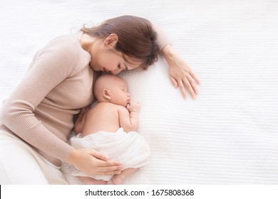 Asian Beautiful Mom Motherhood Lie Down Nursing, Kissing Newborn Baby Infant Toddler, Gently Hold Together On Chest With Love, Infant Sleep Comfortable With Safe And Protection By Mother Taking Care