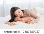 Asian beautiful mother motherhood  lie down nursing, kissing newborn baby, Touch baby