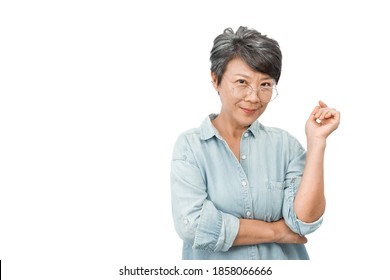 Asian Beautiful Old Woman With Gray Hair, Wearing Glasses And Casual Blue Shirt, Smiling Look At The Camera. Isolated Over White Background. Elegant And Happy Elderly Concept.