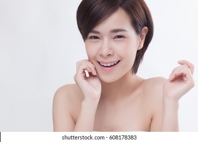Asian beautiful smiling girl with short hair and touching her face to show her healthy skin on the isolated white background