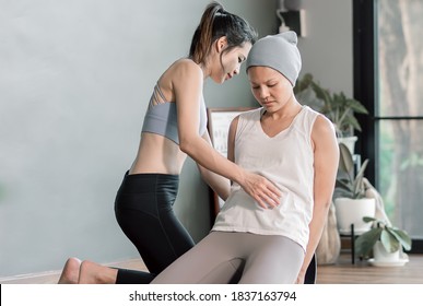 Asian Beautiful Sportive Trainer Is Coaching A Cancer Patient To Do Exercise And Yoga At Home. Sport And Health Concept.