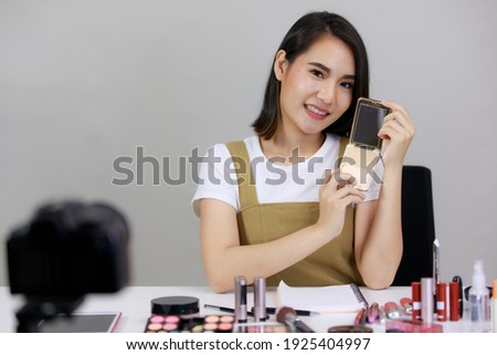 Asian beautiful woman are broadcasting live on smartphones viral video clip by camera and cosmetics makeup in online shopping in the room at home. Concept online shopping Sell