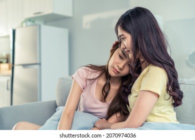 Asian beautiful woman comforts upset girl friend crying for problem. Attractive carring female support, consoling and understand empathy to stressed young sister in tears at home. Family relationship. - Powered by Shutterstock