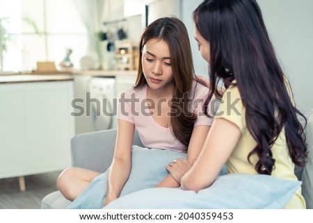 Asian beautiful woman comforts upset girl friend crying for problem. Attractive carring female support, consoling and understand empathy to stressed young sister in tears at home. Family relationship.