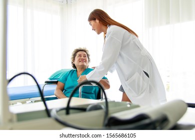 Asian Beautiful Woman Doctor Smiles And Makes Eye Contact With The Old Lady Patient. The Old Lady Entered The Car. Encouraging The Sick