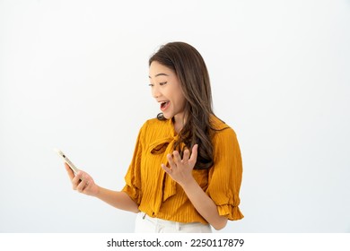 Asian beautiful woman exited surprise face expression . female feels shocked with the phone. exciting smile and happy adorable rejoices. Very enjoy and fun relax time. wow, girl holding smartphone. - Powered by Shutterstock