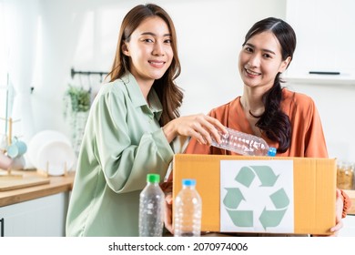 Asian Beautiful Woman Friend Separate Trash For Recycling At Home Together. Attractive Lesbian Couple Put Plastic Bottles Into Recycle Box For Ecologically Friendly And Saving Environment Zero Waste.