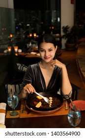 Asian Beautiful Woman Have Dinner In Luxury Roof Top Restaurant With Secret Recipe Menu On Plate Course Set Of Spanish Food Cuisine Culinary Which A Bit Hot And Unique Taste On Wooden Table.