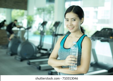 Asian Beautiful Woman Holding Water Bottle At Gym, Woman Exercise At Gym Concept.