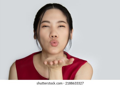 Asian Beautiful Woman Are Make  Blow Kiss Or Pucker Up Her Lips To Send Her Love With A Happiness.