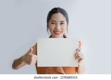 Asian Beautiful Woman Make Thumb Up Gesture Hand Sign And Holding White Paper Or Board For Writing Text Or Information To Communicate To People 