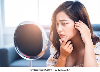 Asian Beautiful Woman Self Awareness Lack Confidence Spots Pimple Zits Face Problem Feeling Stress Sad Worry Concern Bad Unhealthy Skin Care Aging Issues Looking Into Mirror, At Home In Living Room 