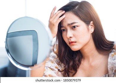 Asian Beautiful Woman Self Awareness Lack Confidence Spots Pimple Zits Face Problem Feeling Stress Sad Worry Concern Bad Unhealthy Skin Care Aging Issues Looking Into Mirror, At Home In Living Room 