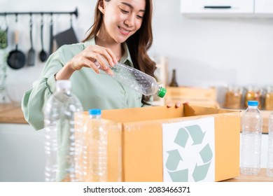 Asian Beautiful Woman Separating Trash For Further Recycling At Home. Attractive Female Put Plastic Bottles Into Recycle Box For Ecologically Friendly And Saving The Environment. Zero Waste Concept.