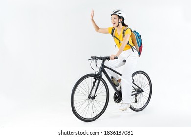 Asian Beautiful Woman, She Is Riding A City Bike To Work.She Is Greeting.studio Concept