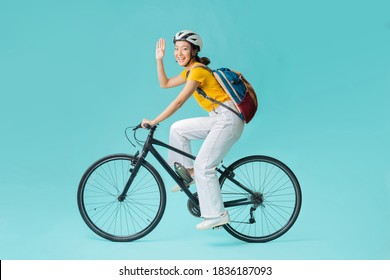 Asian Beautiful Woman, She Is Riding A City Bike To Work.She Is Greeting.studio Concept