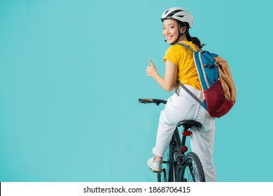 Asian Beautiful Woman, She Is Riding A City Bike To Work