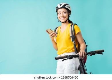 Asian Beautiful Woman, She Is Riding A City Bike To Work.She Is Using The Phone