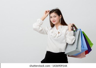 Asian Beautiful Woman With Shopping Bags Of Various Colors, Standing On A White Background Online Shopping Concept