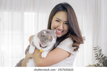 Asian Beautiful Woman Smiling And Hug Her Cat While Taking Rest At Home. Lifestyle And Pet Concept.