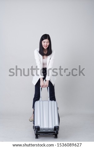Asian beautiful woman woman tourist with gray color luggage to travel on his vacation isolated on light gray studio banner background with copy space
