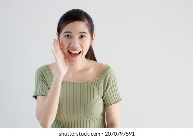 Asian Beautiful Woman Wear Green T-shirt Are Telling Or Whisper A Secret For News And Information. 