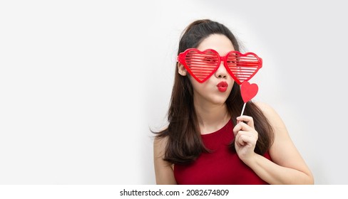 Asian Beautiful Woman Are Wearing Big Red Eyeglasses And Hold Red Heart Paper With Kiss Or Pucker Up Her Lips With Happiness 