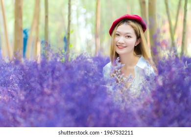 Asian beautiful young lady smiles while stands in purple flower garden like lavender flower in natural theme. - Powered by Shutterstock