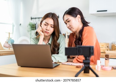 Asian Beauty Blogger Influencer Woman Checking Sale Order On Computer. Attractive Beautiful Business Lesbian Friend Vlogger Sit On Table, Using Laptop Computer To Look At Financial Problem In House.