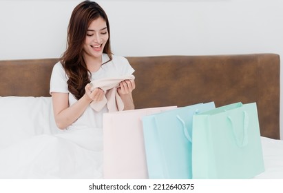 Asian Beauty Woman Surprised With Paper Bags With Goods With A Happy Smiling Face, Being A New Normal Online Business In The Shopping Experience From Home