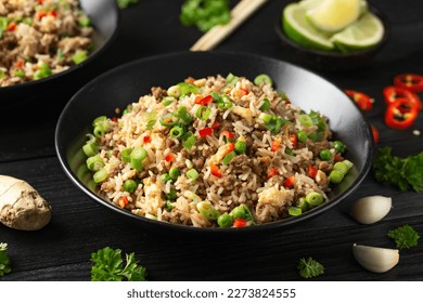 Asian Beef Fried Rice with eggs and vegetables in black bowl - Powered by Shutterstock