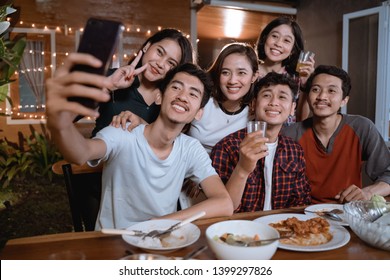 Asian Bestfriend Group Take Selfie With Smartphone While Having Garden Party Dinner Together