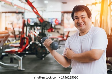 Asian Big Fat Overweight Men Smiling Is Exercise Wiht Dumbbells Isolated On White Background.