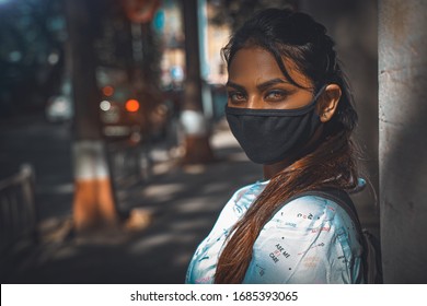 Asian Black Young Woman Wearing Black Color Face Mask During Coronavirus Outbreak. Virus Spread Flu Prevention Carnitine. Girl In A Facemask On A Streets Of Mumbai