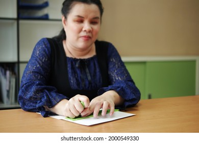 Asian Blind Person Woman Hands Writing Braille By Using Slate And Stylus Tools Making Embossed Printing For Braille Character Encoding. Braille Is A System Of Raised Dots For Vision Disability People.