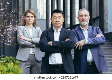 Asian Boss With Team, Portrait Of Group Of People With Crossed Arms Looking At Camera, Diverse Business People Outside Office Building Standing Focused