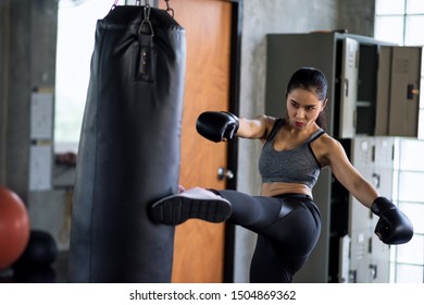Asian Boxing Woman Kicking Huge Punching Bag At Fitness Gym. Athletic Sexy Girl Training Thai Boxing Punch And Kick For Bodybuilding And Healthy Lifestyle Concept. Happy Woman Workout In Sport Club.