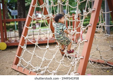 Asian Boy About 2 Year And 3 Months In Military Suit Playing And Having Fun At Kid Training Playground For Muscle Development