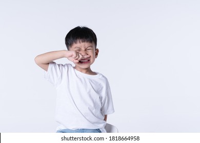 Asian boy about 4 year olds blocking his nose as bad smell gesture