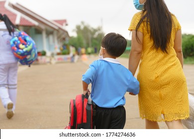 Asian Boy About 4 Years Old In Northern Thai Traditional Cloth Wearing Face Mask And Walking To Pre Elementary Or Kindergarten School With His Mother