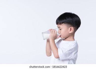 Asian Boy About 4 Years Old Drinking Milk From Glass