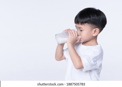 Asian Boy About 4 Years Old Drinking Milk From Glass