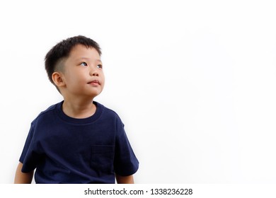 Asian Boy In Blue Shirt Looking To His Left On A White Background