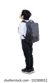 Asian Boy Carrying Backpack, Shot From Behind Isolated On White Background