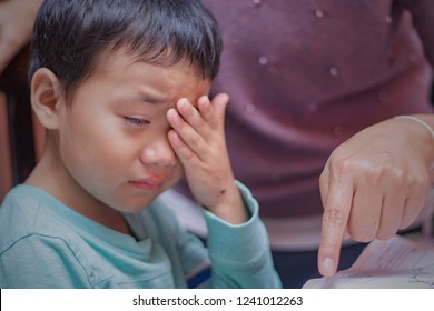 Asian Boy Or Boy Crying With Sadness Or Sickness On A Black Tabl