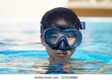 Asian Boy In A Diving Mask In The Pool
