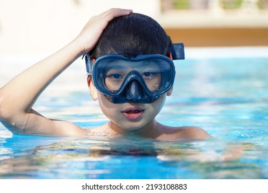 Asian Boy In A Diving Mask In The Pool
