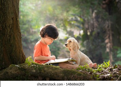 Asian Boy And Dog. Kid Read Book. Child And Puppy Under Tree. American Cocker Spaniel Home Pet. Domestic Animal. School And Education. Nature And Park. Early Learning. Summer Outdoor. Best Friends. 