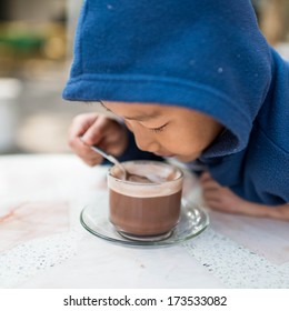 Asian Boy Drinking Hot Chocolate In The Morning.